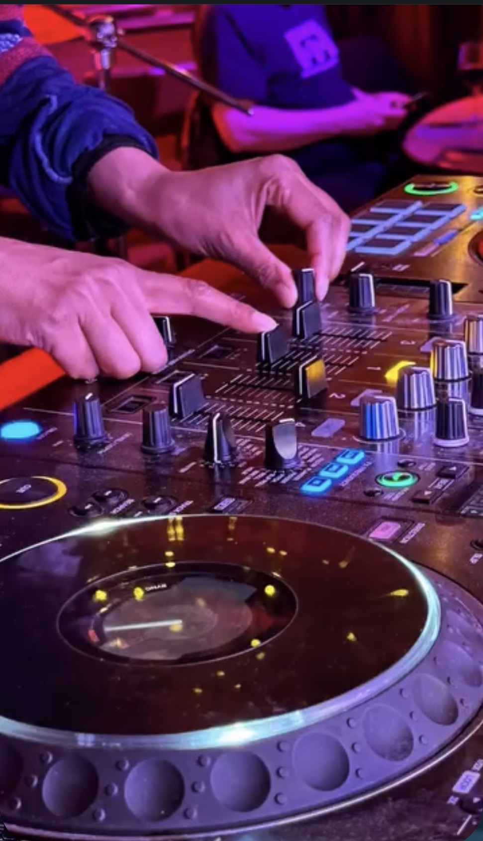 Young people learning to DJ on professional equipment