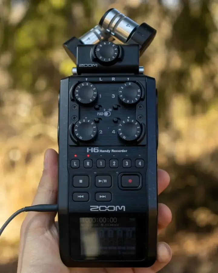 Handheld recorder capturing sound outdoors