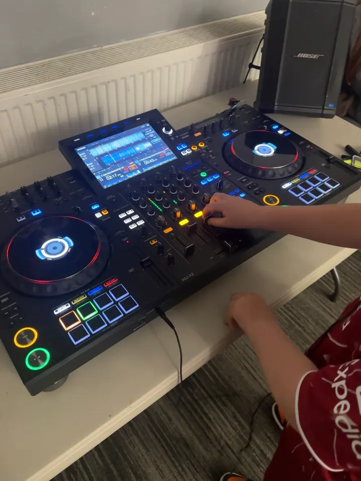 A participant mixing on the DJ decks